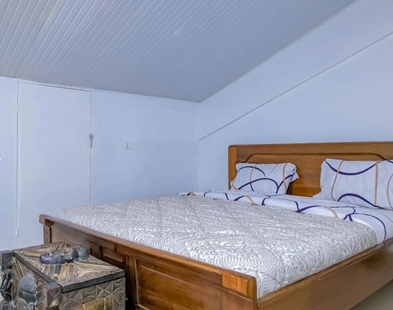 An upstairs bedroom under the slope of the roof