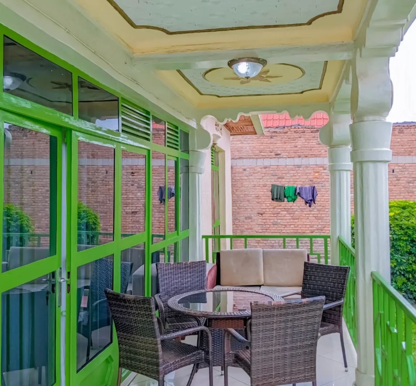 The covered balcony, with a table and chairs