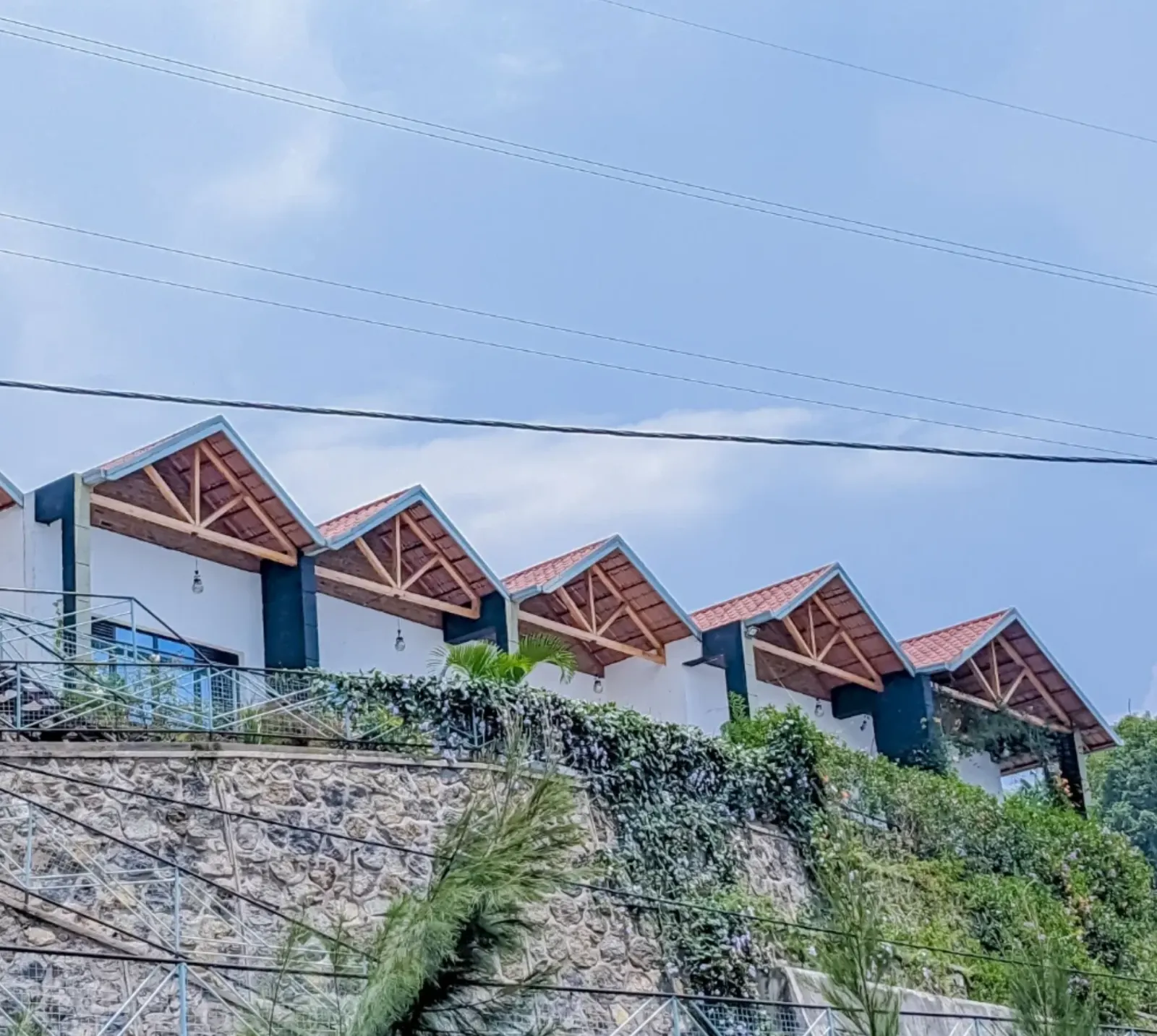 The row of gabled roofs above the stone wall