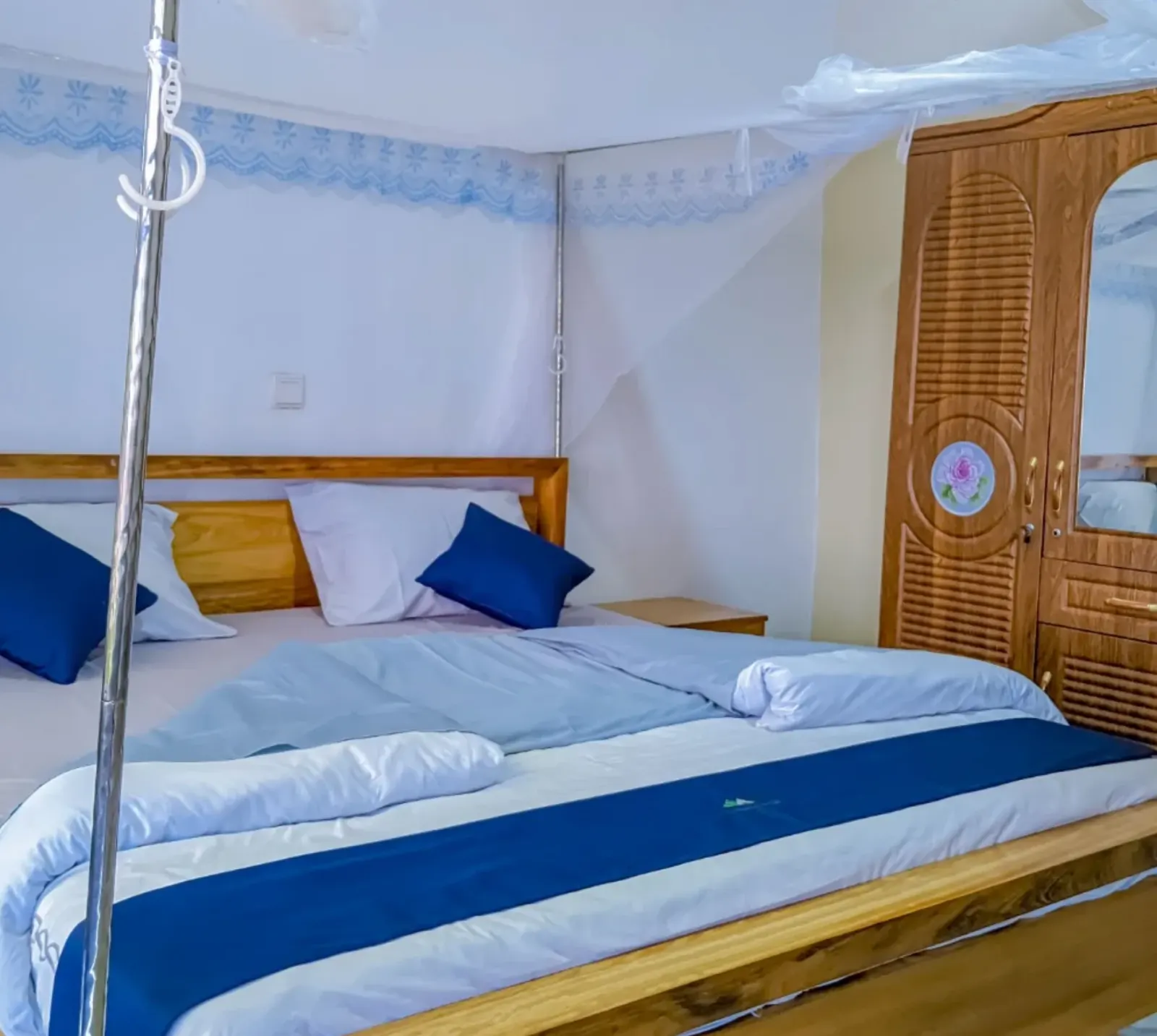 A bedroom, with a mosquito net and wardrobe